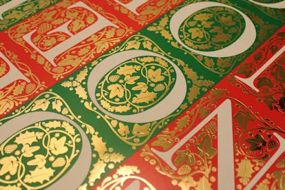 Gold foil blocking on red and green card